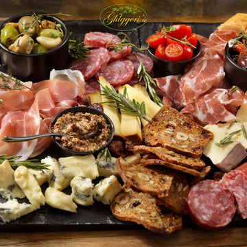 Platter of cured meats, cheeses, and crackers with Gliggeri's logo.