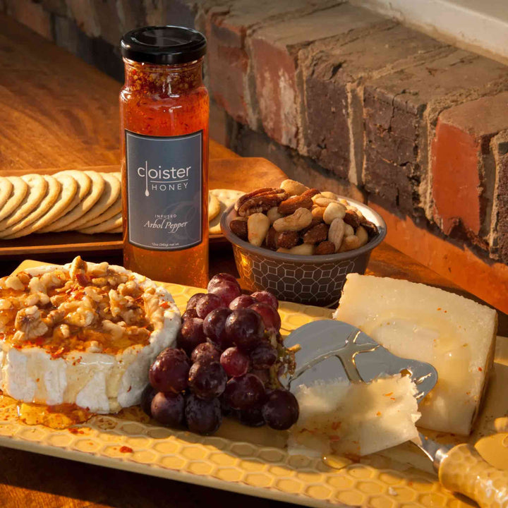 Jar of Cloister Árbol Infused Honey – golden Carolina honey with chile de árbol peppers for sweet heat.