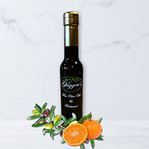 Balsamic vinegar bottle with oranges and grapes on a white background