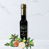 Savory olive oils with roasted onion and olive branch on light background