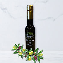 Bottle of extra virgin olive oil with olive branch on a white background