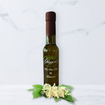 Elderflower white balsamic vinegar bottle with delicate elderflower blossoms and lemon slices