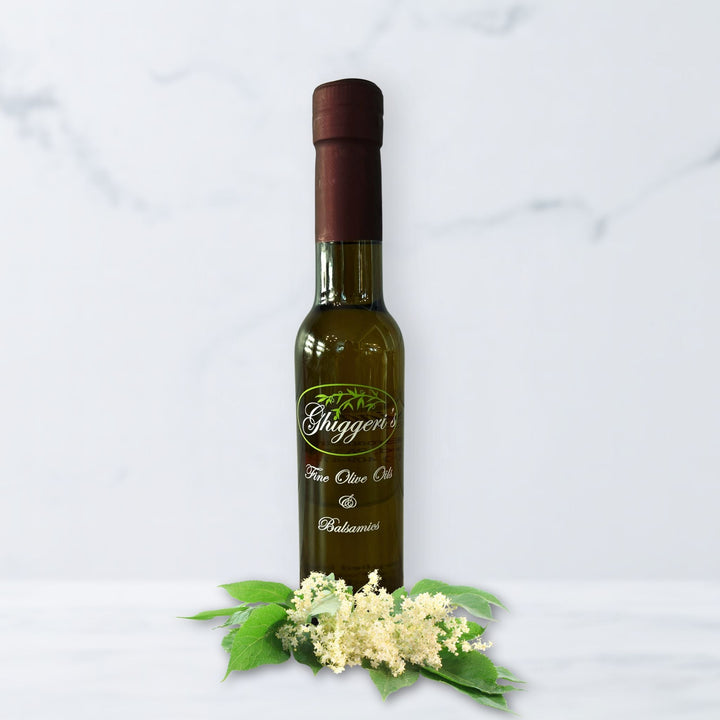 Elderflower white balsamic vinegar bottle with delicate elderflower blossoms and lemon slices