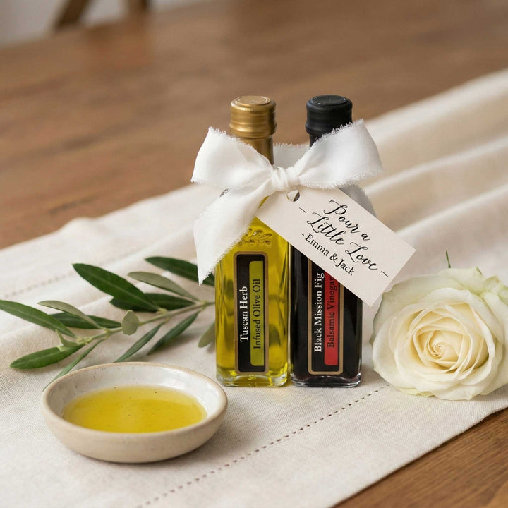 Close-up of a single Ghiggeris olive oil wedding favor bottle styled on an elegant reception table with white floral centerpieces.