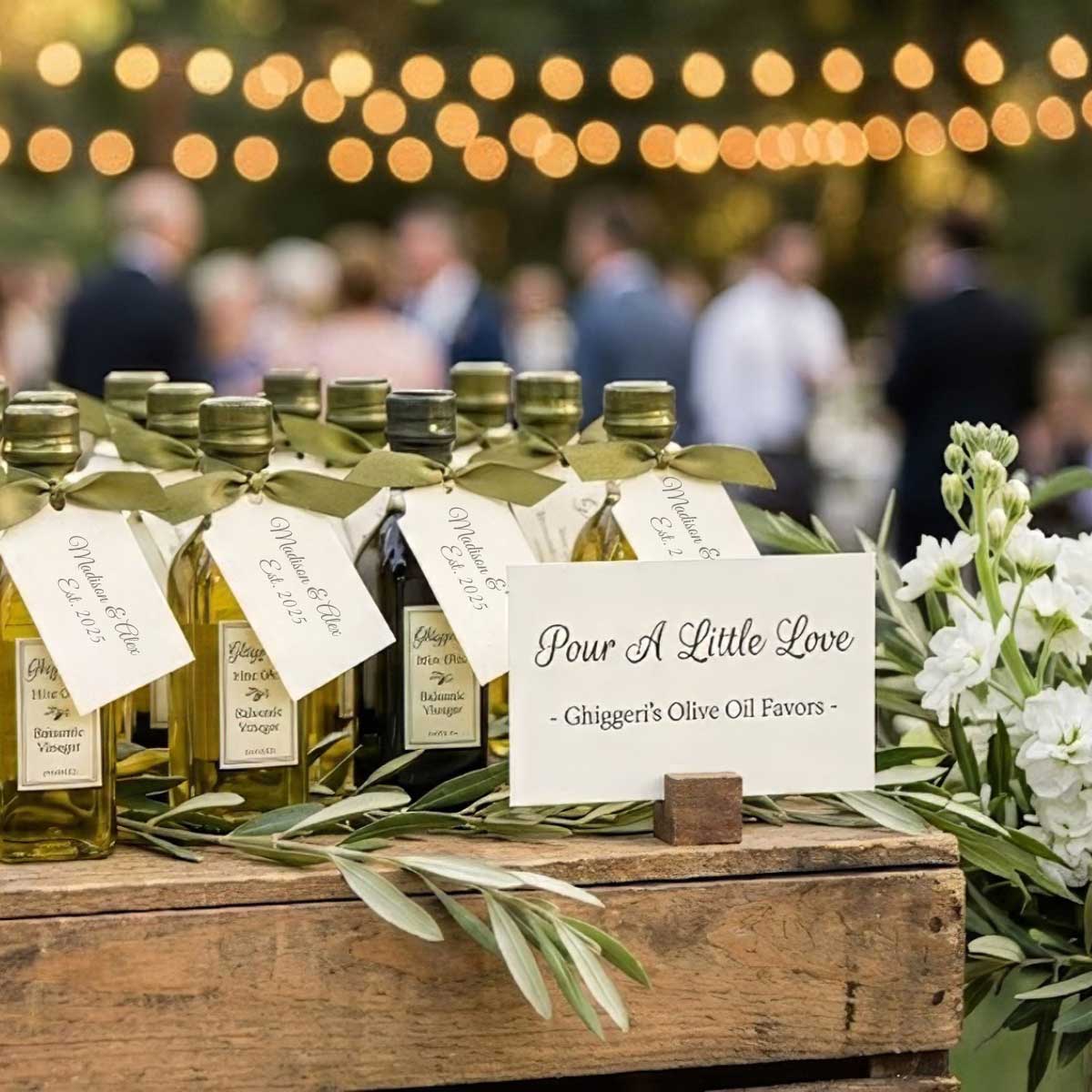 Rustic wedding reception display of Ghiggeri's olive oil favors on a wooden crate, featuring a sign that reads 'Pour A Little Love