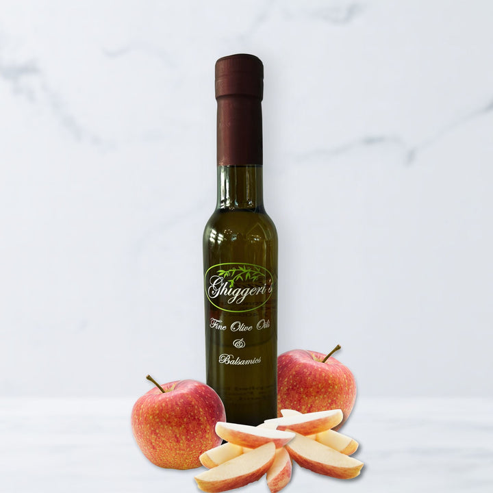 Gravenstein apple white balsamic vinegar bottle with fresh green and red apples