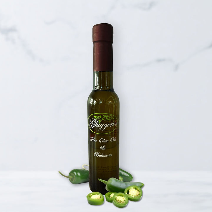Spicy jalapeño white balsamic vinegar bottle with fresh peppers and lime

