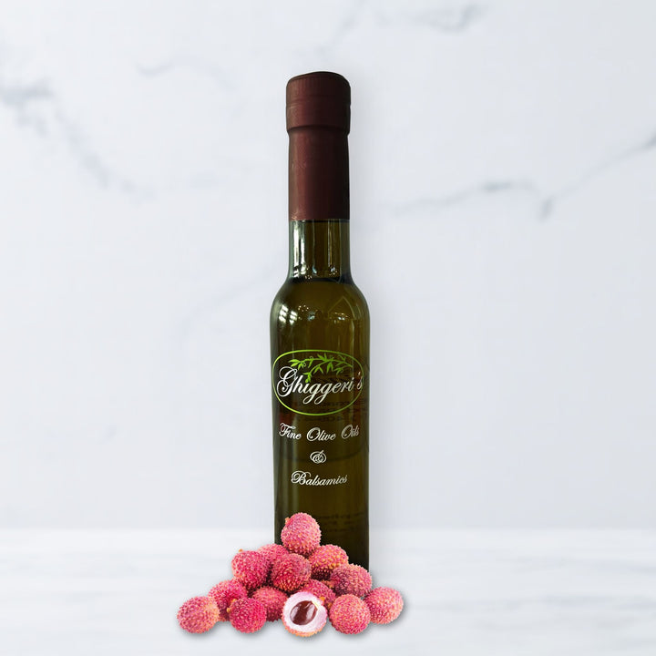 Tropical lychee white balsamic vinegar bottle with fresh lychee fruit

